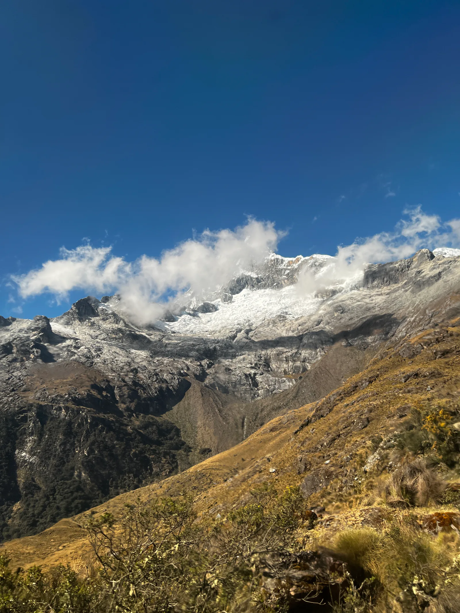 Snowy ridges above golden slopes
